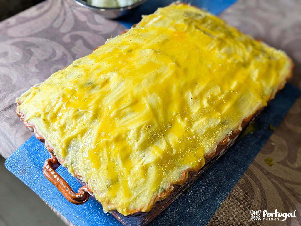 A baked rectangular dish of Escondido Cod, topped with mashed yellow potatoes.