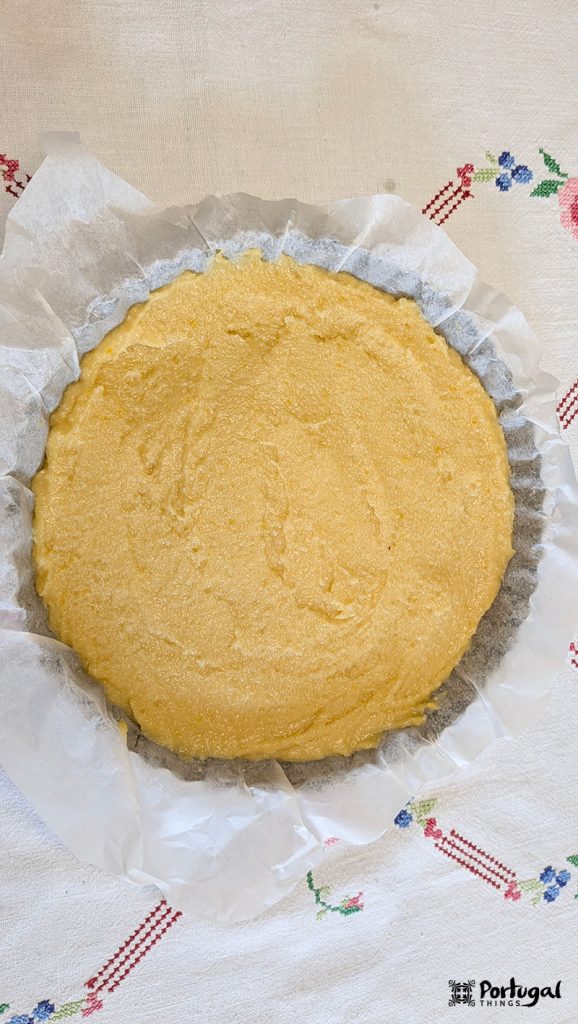 dough for the pie topping in a tart pan covered with parchment paper