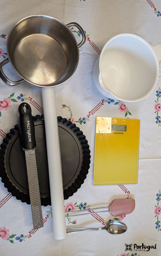 Equipment needed for almond tart: a saucepan, a bowl, a spatula, and other basic kitchen tools.