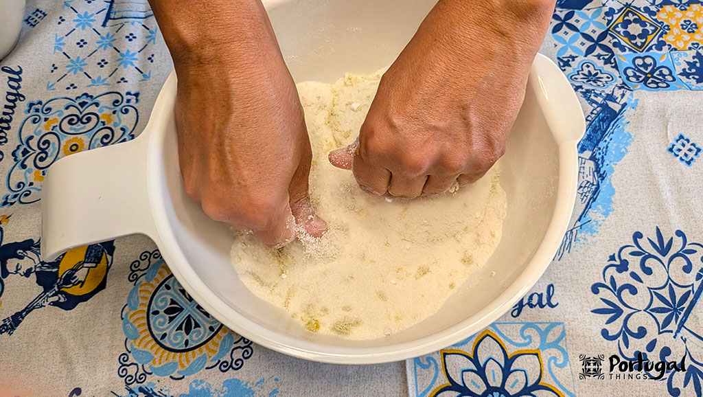 Use both hands to mix and crumble the lemon zest with the sugar and flour.