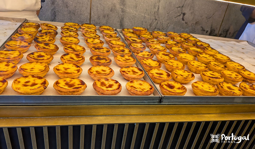 Display of freshly baked pastéis de nata at Castro in Lisbon