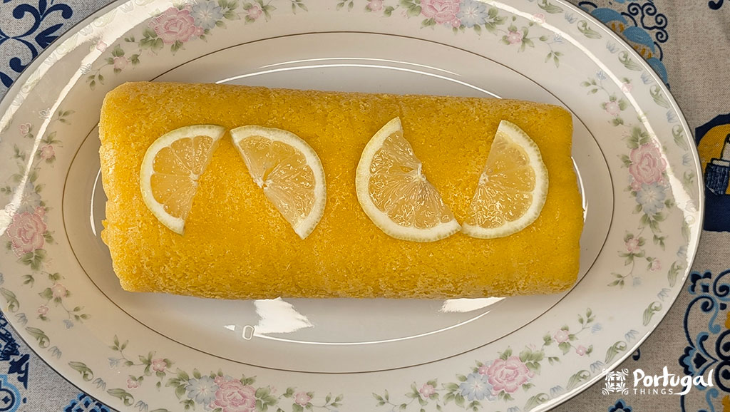Lemon pie decorated with a few lemon slices on top, served on a platter.