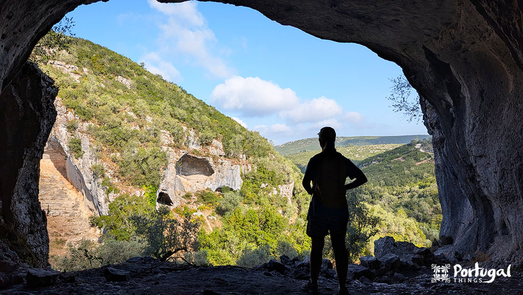 Buracas do Casmilo: Como Fazer o Trilho e Visitar as Grutas 6 uma pessoa dentro do Buraco do Casmilo a olhar para a paisagem
