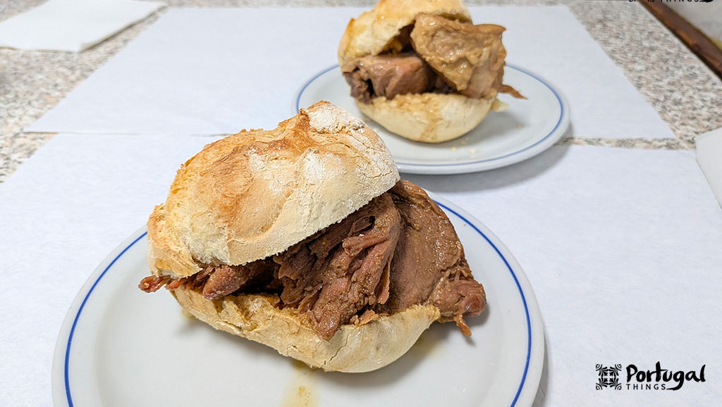 duas sandes com um molete recheadas de rojões numa mesa branca
