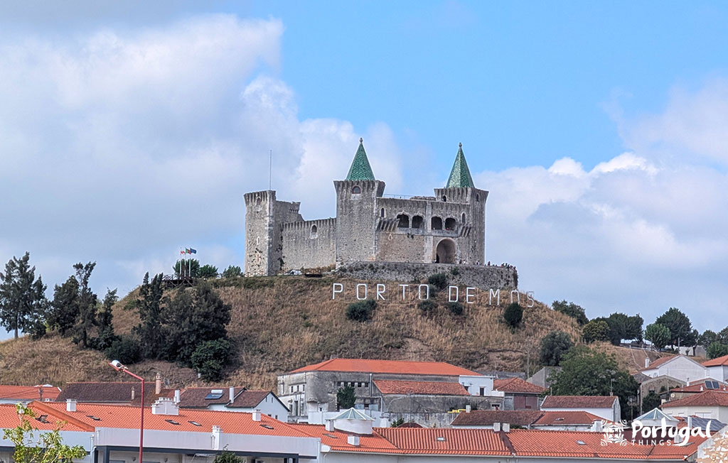 Porto de Mós Ecotrail: Trail, Tunnels, and Windmills 9 A castle on top of a hill surrounded by houses