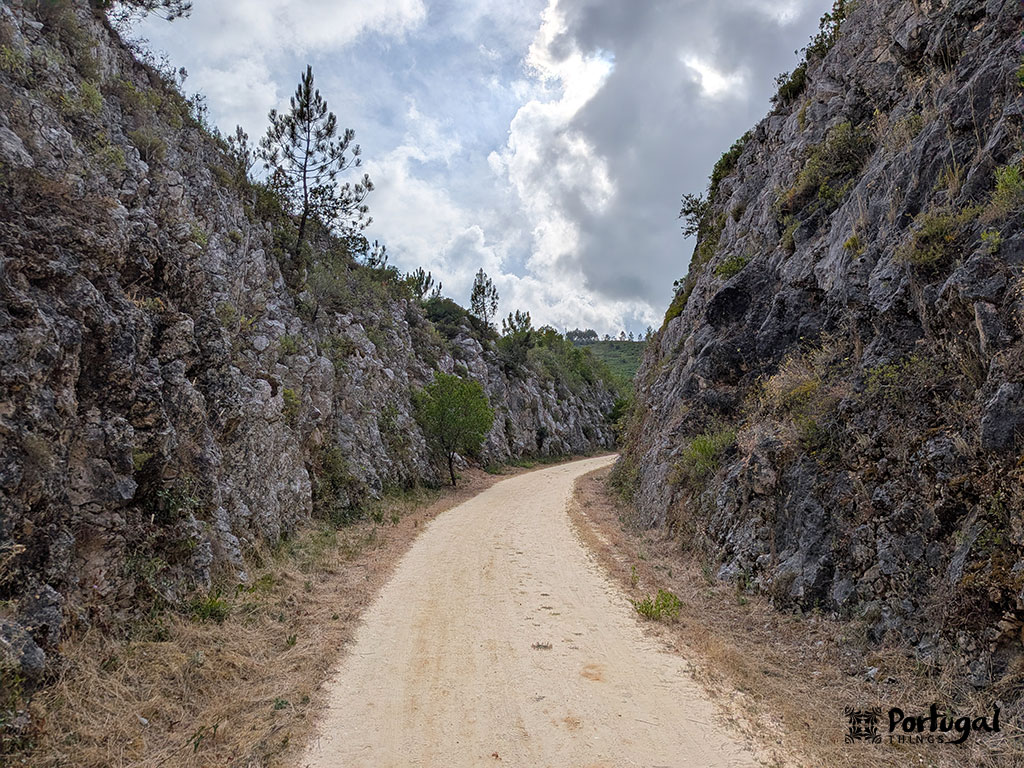 Porto de Mós Ecotrail: Trail, Tunnels, and Windmills 3 Rocky gorge with a dirt trail running through it