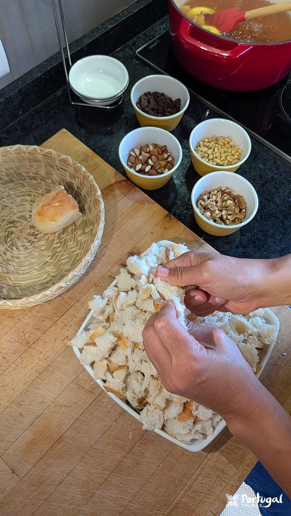 Mexidos: A Traditional Portuguese Christmas Dessert 5 A hand cutting bread into pieces beside a plate full of crumbled bread.