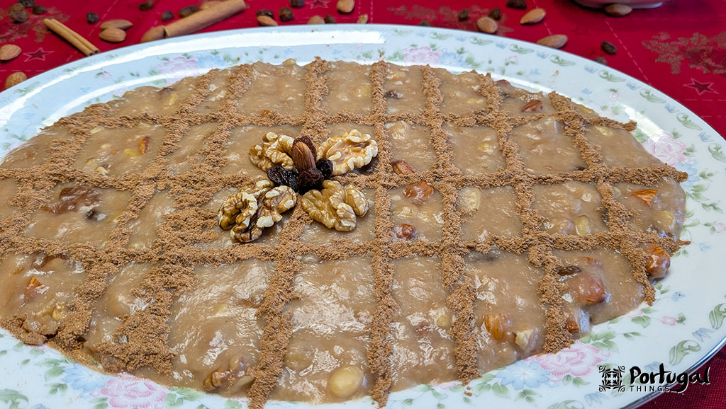 Mexidos: A Traditional Portuguese Christmas Dessert 11 A serving dish of formigos decorated with cinnamon in a striped pattern and nuts.