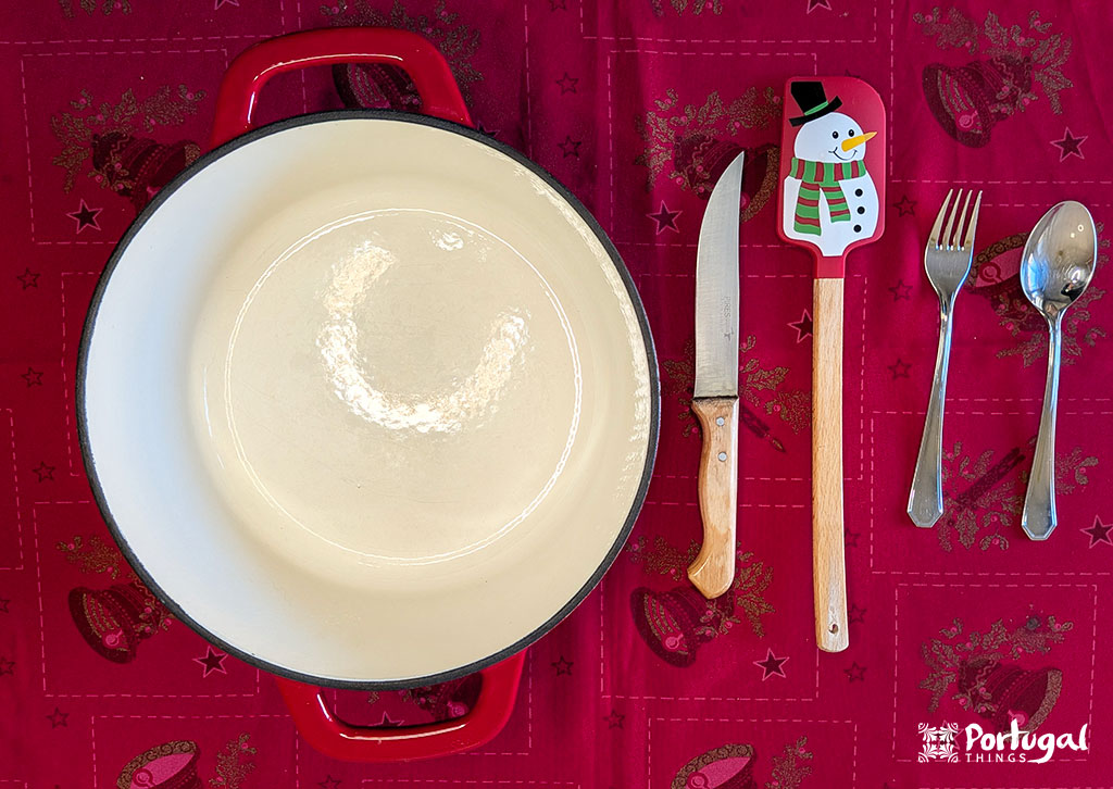 Mexidos: A Traditional Portuguese Christmas Dessert 2 A saucepan, knife, spatula, spoon, and fork on a red tablecloth.